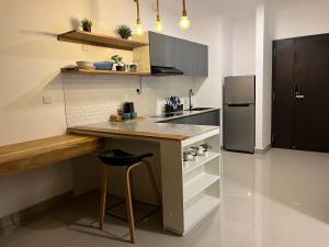 a kitchen with a counter and a refrigerator at Beachside Studio Retreat in Negombo
