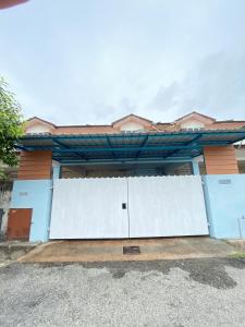 a house with white gates in front of it at Homestay Temerloh with private pool, Yhc Homestay in Temerloh