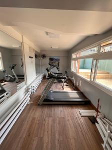 a gym with two exercise bikes in a room at Loft no centro de Joinville in Joinville