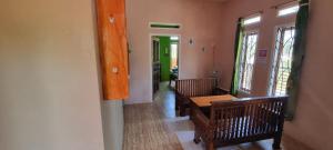 a hallway with a table and chairs in a house at Dam Ri Private 2nd Floor - Near Airport & Batukaras in Tjidjulang