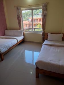 Una cama o camas en una habitación de Hotel Green Hill View