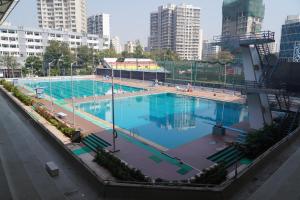 an overhead view of a large swimming pool in a city at Country Inn by UMRB in Mumbai