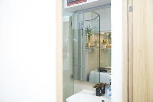 a bathroom with a sink and a mirror at Shore2 Luxurious & Homely Suite near MOA in Manila
