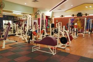 a gym with a lot of tread machines at Country Inn by UMRB in Mumbai