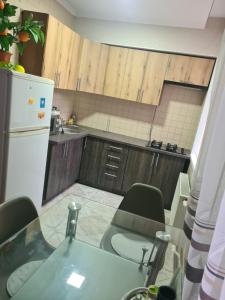 a kitchen with a table and chairs and a refrigerator at Аpartments on the main street in Bălţi +1 photo