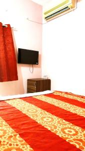 a bedroom with a red rug on the floor at HOTEL HELIX -- RAJPURA -- Budget Rooms for Family, Couples, Solo Travellers in Rājpura