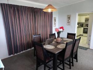 a dining room with a table with a laptop on it at Tugela Mouth Sea View Guest House (Sleeps 8) in Tugela Mouth