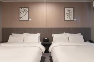 Ένα ή περισσότερα κρεβάτια σε δωμάτιο στο Workers Hotel Ansan by Aank