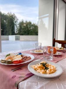 een tafel met borden eten op een roze tafelkleed bij Ośrodek Magnolia in Ustroń