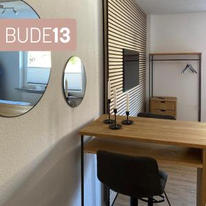 een kamer met een bureau en een spiegel bij S17 ferienappartments in Flensburg