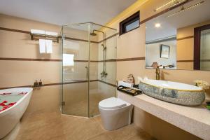 a bathroom with a tub and a sink and a shower at La Charm Hoi An Hotel - Peaceful Boutique In Old Town in Hoi An