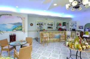 a restaurant with a bar with tables and chairs at Locanda Costa D'Amalfi in Amalfi