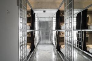 a room with a hallway with bunk beds at 軟寓 nńg inn in Tainan