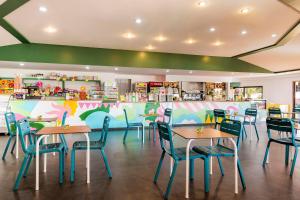 a restaurant with tables and chairs and a counter at Gitavillage California in Montalto di Castro