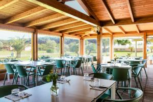 an empty dining room with tables and chairs at Gitavillage California in Montalto di Castro