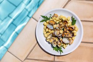 a plate of food with seafood on a table at Gitavillage California in Montalto di Castro