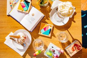 a wooden table topped with a table topped with ice cream at Gitavillage California in Montalto di Castro