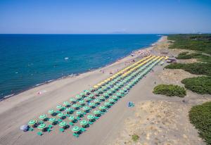 an overhead view of a beach with umbrellas and the ocean at Gitavillage California in Montalto di Castro