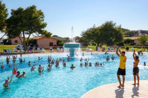 a group of people in a swimming pool at Gitavillage California in Montalto di Castro