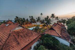 an aerial view of roofs of a building with a pool at Cocobay Resort Kumarakom in Kumarakom