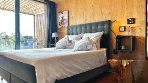 a bedroom with a large bed with a blue headboard at My Happy Box in Ochsenfurt