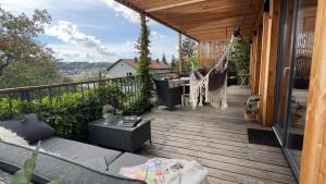 a wooden deck with a hammock on a house at My Happy Box in Ochsenfurt +26 photos