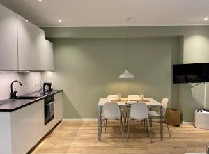 a kitchen with a table and chairs in a room at Condo Apartments Hamburg in Hamburg