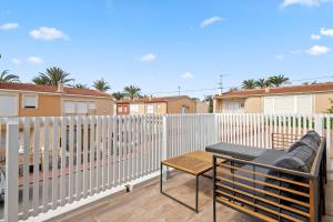 a balcony with a table and a fence at Casa Plugge in Torrevieja