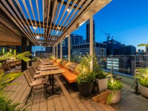 an outdoor patio with a long wooden table and benches at GINZA HOTEL by GRANBELL in Tokyo
