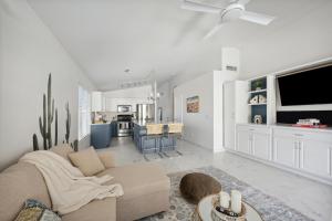 a living room with a couch and a kitchen at Chic Desert Retreat - Lush Spa Pool - Mini Golf in Phoenix