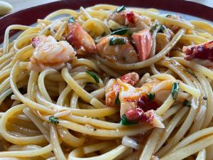 a plate of pasta with shrimp on top of it at Les Herbes Flottantes in Englesqueville-en-Auge