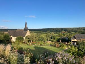 a view of the garden from the house at Les Herbes Flottantes in Englesqueville-en-Auge