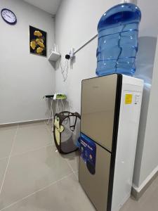 a refrigerator with a water tank on top of it at TAMU ROOMSTAY TOK MOLOR in Kuala Terengganu