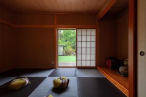 a japanese room with a door and a window at S-villa Nasu 6th in Anazawa