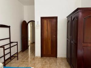 a room with a closet and a wooden door at Manik Villa in Bentota
