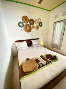 a bedroom with a bed with towels on it at Salt Life Gili Trawangan in Gili Trawangan