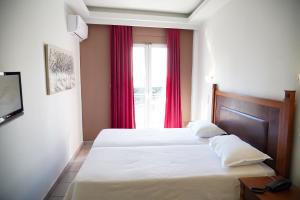 Postel nebo postele na pokoji v ubytování Hotel Selini
