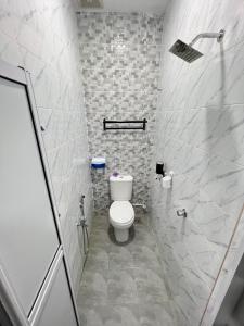 a bathroom with a toilet and a walk in shower at TAMU ROOMSTAY TOK MOLOR in Kuala Terengganu