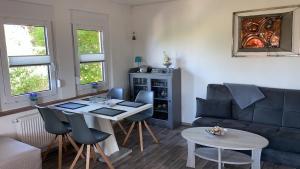 ein Wohnzimmer mit einem blauen Sofa und einem Tisch in der Unterkunft Ferienhaus Kastanienallee in Meiningen