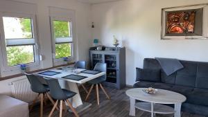 a living room with a blue couch and a table at Ferienhaus Kastanienallee in Meiningen