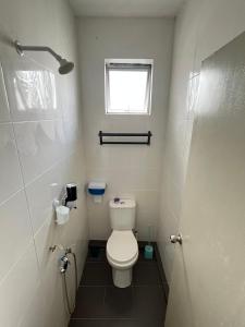 a small bathroom with a toilet and a window at TAMU ROOMSTAY TOK MOLOR in Kuala Terengganu