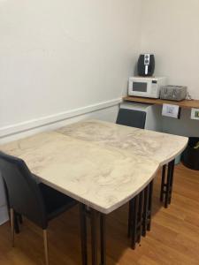 a table and chairs in a room with a microwave at Royal Hotel - Accommodation only in Parkes