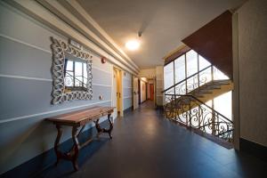 a hallway with a bench and stairs in a building at Park Hotel Residence in Orbetello
