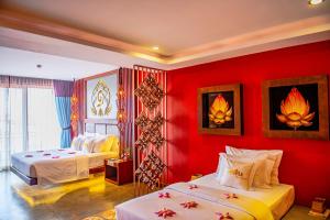 a hotel room with two beds and red walls at Golden Temple Boutique in Siem Reap