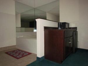 a room with a kitchen with a counter and a microwave at Western Inn & Suites Hampton in Hampton