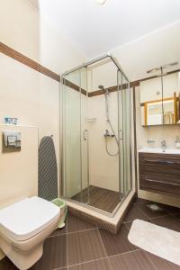 a bathroom with a glass shower and a toilet at Apartments Šiljug in Cavtat +53 photos