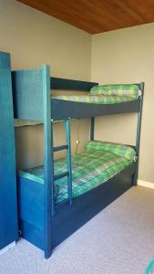 two bunk beds are in a room with at L'Ariondaz - Appartement au centre du village, proche des pistes, avec parking in Courchevel