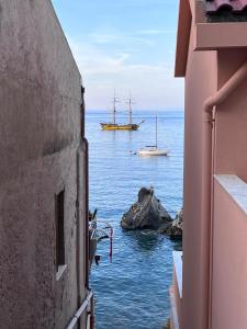 a view of the ocean with a ship in the water at LA CASETTA AZZURRA CHIANALEA - locazione turistica in Scilla +28 photos