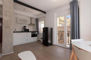 a kitchen with a black refrigerator and a balcony at Apartamento Santa Maria by Be Alicante in Alicante