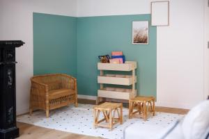 Cette chambre est dotée d'un mur bleu avec une chaise et un tabouret. dans l'établissement Sweet Inn - Rue Des Chartreux, à Bruxelles